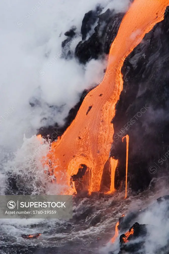 Hawaii, Big Island, near Kalapana, Pahoehoe lava flowing from Kilauea into frothy Pacific Ocean