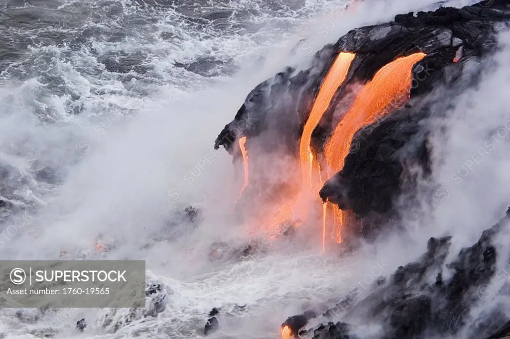 Hawaii, Big Island, near Kalapana, Pahoehoe lava flowing from Kilauea into frothy Pacific Ocean