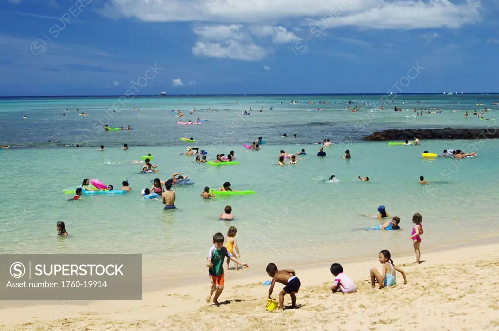 Hawaii, Waikiki Beach crowded with tourists and children on a sunny day. NO MODEL RELEASE