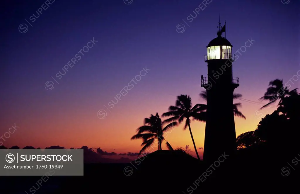 Hawaii, Oahu, Diamond Head Lighthouse silhouetted at sunset.