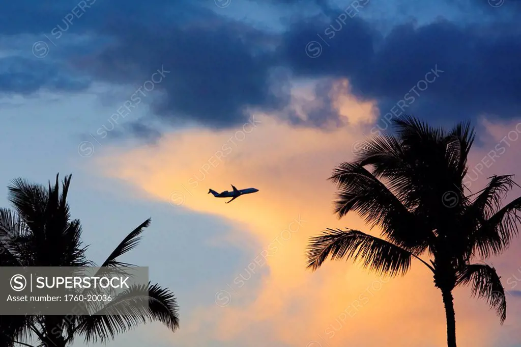 Hawaii, Beautiful clouds a sunset with a silhouette of an airplane.