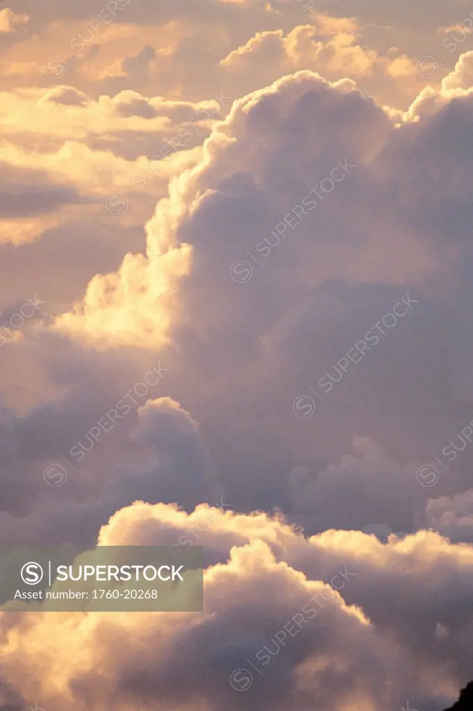 View of large full clouds at sunrise, with shadows