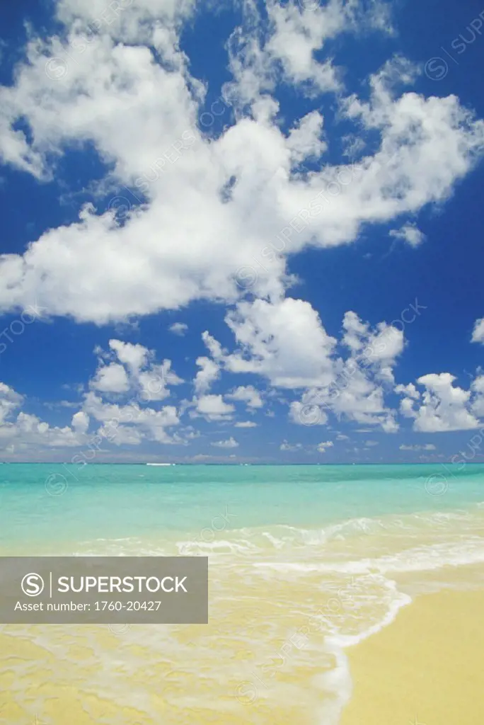 Hawaii, Oahu, Lanikai, gentle wave washing ashore on beach, turquoise water and blue sky.