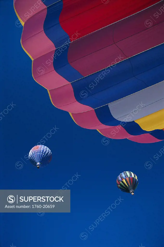Colorful hot air balloons in flight against blue sky @ Reno, Nevada