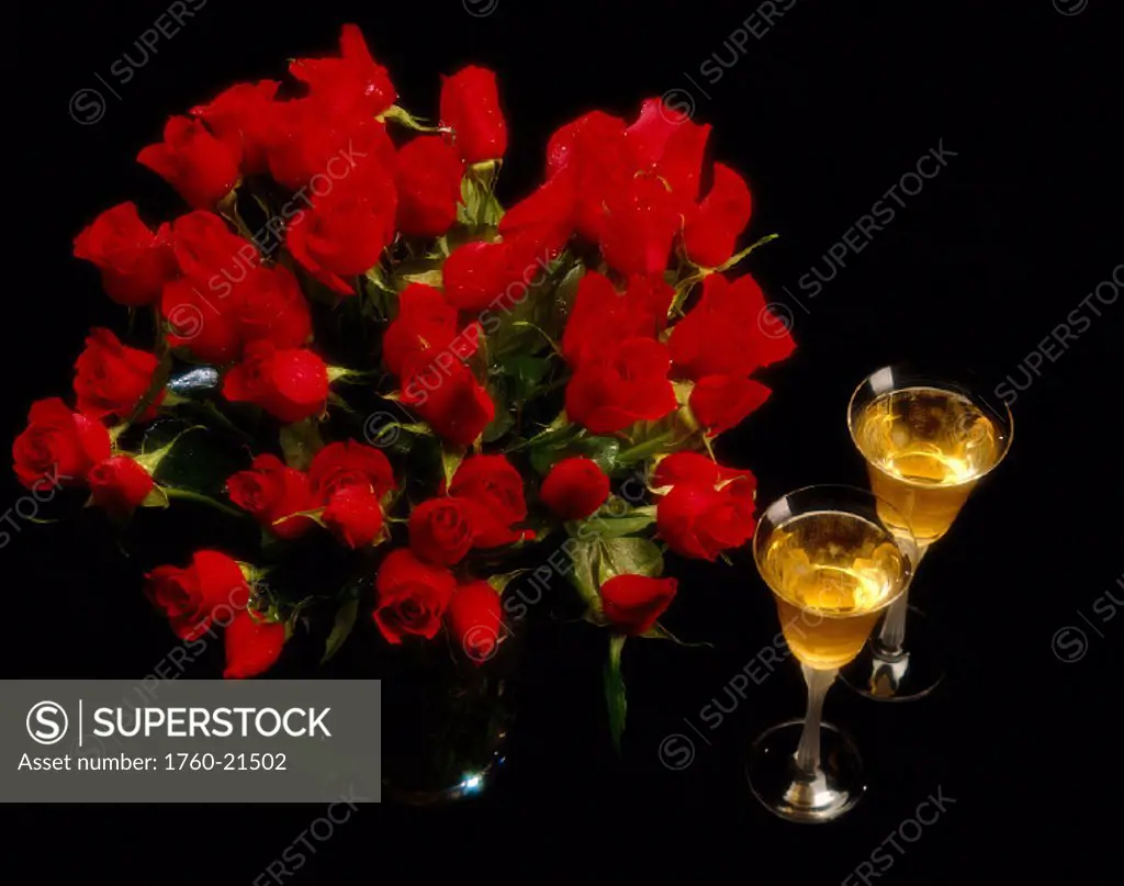 Dozens of red roses and two glasses of white wine B1125