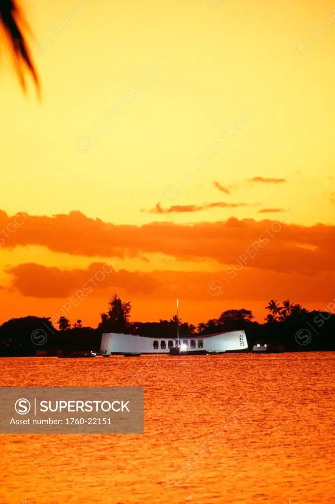 Hawaii, Oahu, Pearl Harbor, Full view of Arizona Memorial at sunset, bright orange yellow sky