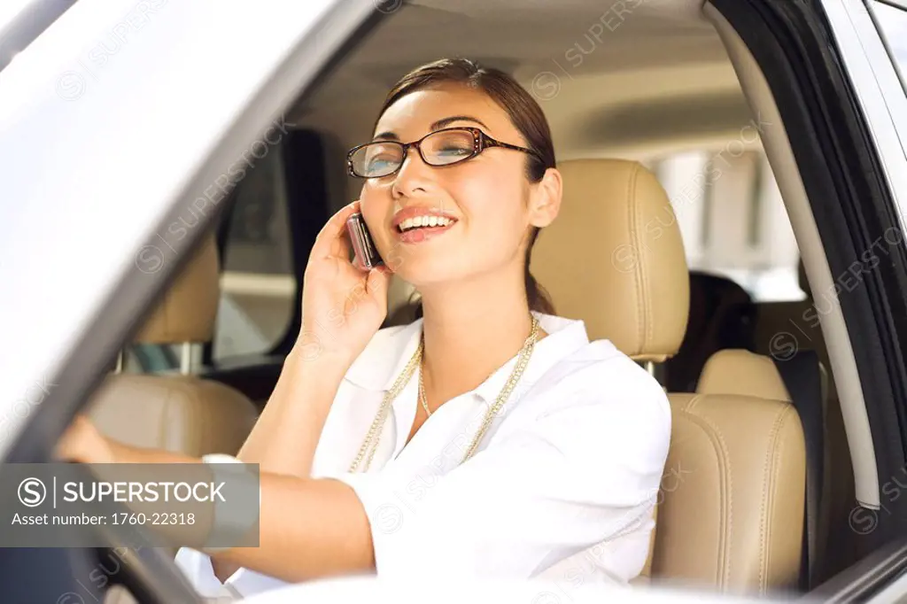 Hawaii, Oahu, Business woman on the phone in her car.