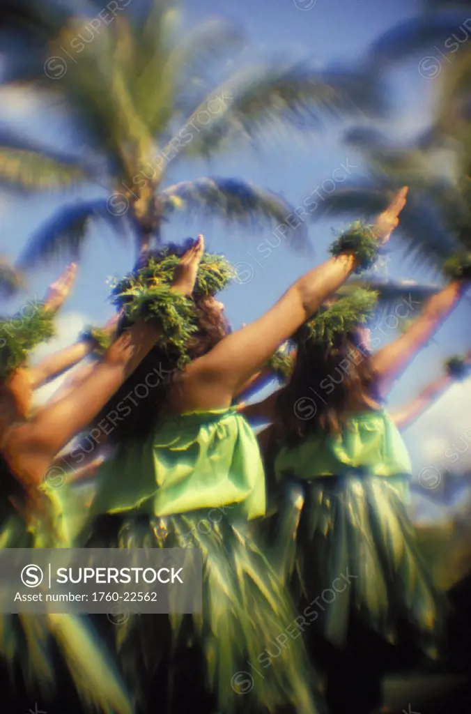 Hawaii, Hula Kahiko, colorful group of wahine dancing with arms up to sky