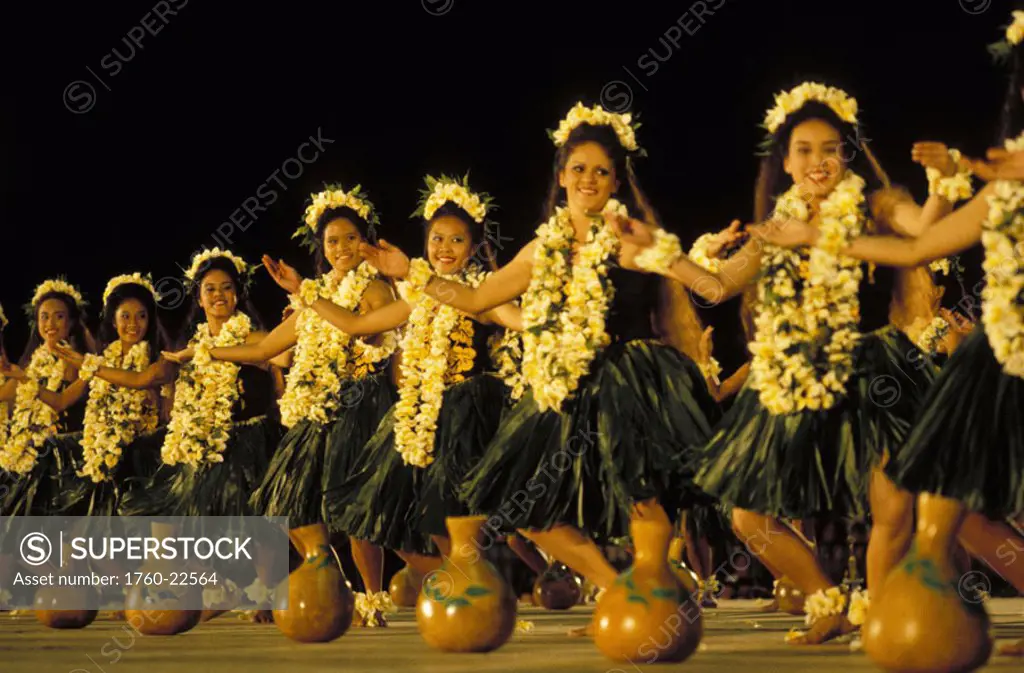 Hawaii, Big Island, Merrie Monarch Hula Festival, halau on stage with plumera leis and ti-leaf skirts, ipus on floor.