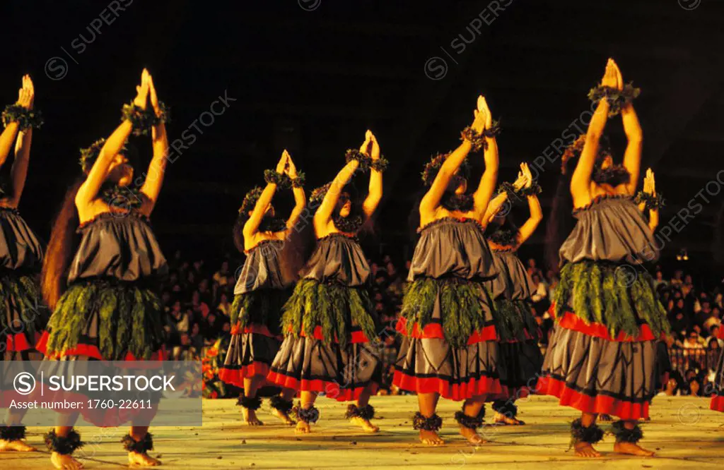 Hawaii, Big Island, Merrie Monarch Hula Festival, Kahiko dancers on stage with arms raised.