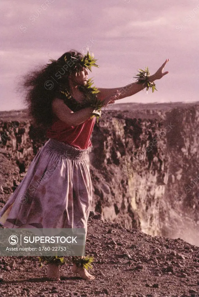 Hawaii, Big Island, Hawaii Volcanoes National Park, Kilauea Crater, local woman hula dancing on rocky ground.