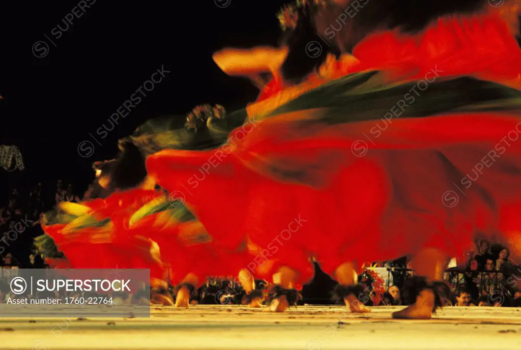 Hawaii, Women dancing hula on stage, blurry red skirts.