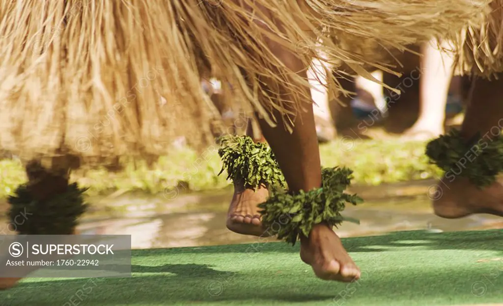 Hawaii, Oahu, close-up of hula dancer feet with grass skirts