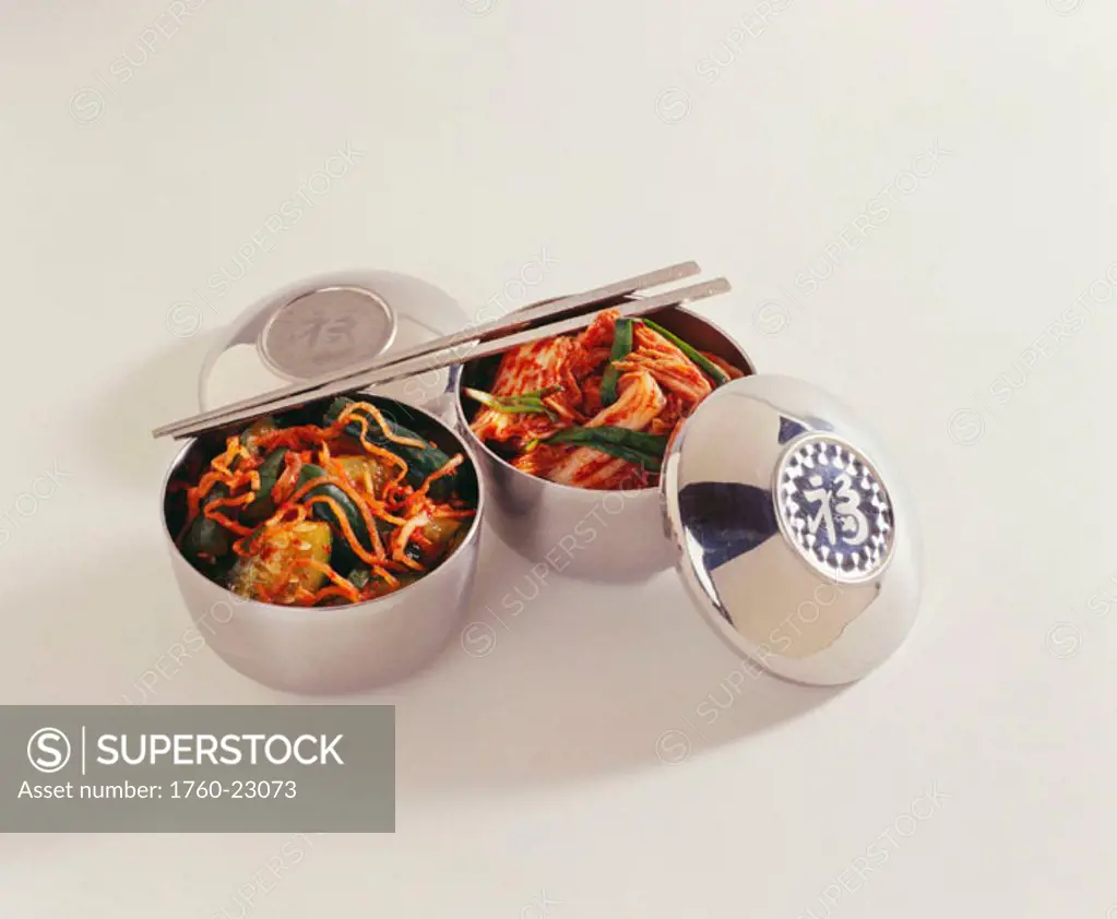 Studio shot of two bowls of kim chee with chopsticks.