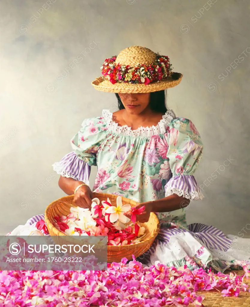 Woman stringing flower leis, Hawaiian attire, muumuu, straw hat