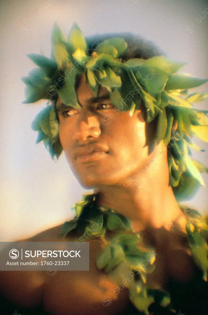 Hawaii, portrait of local man with green lei and haku, head turned, soft focus lighting