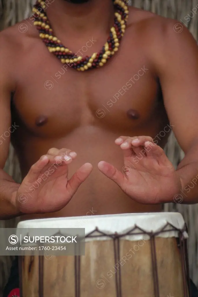Closeup of local man´s hands playing a pahu drum D1476