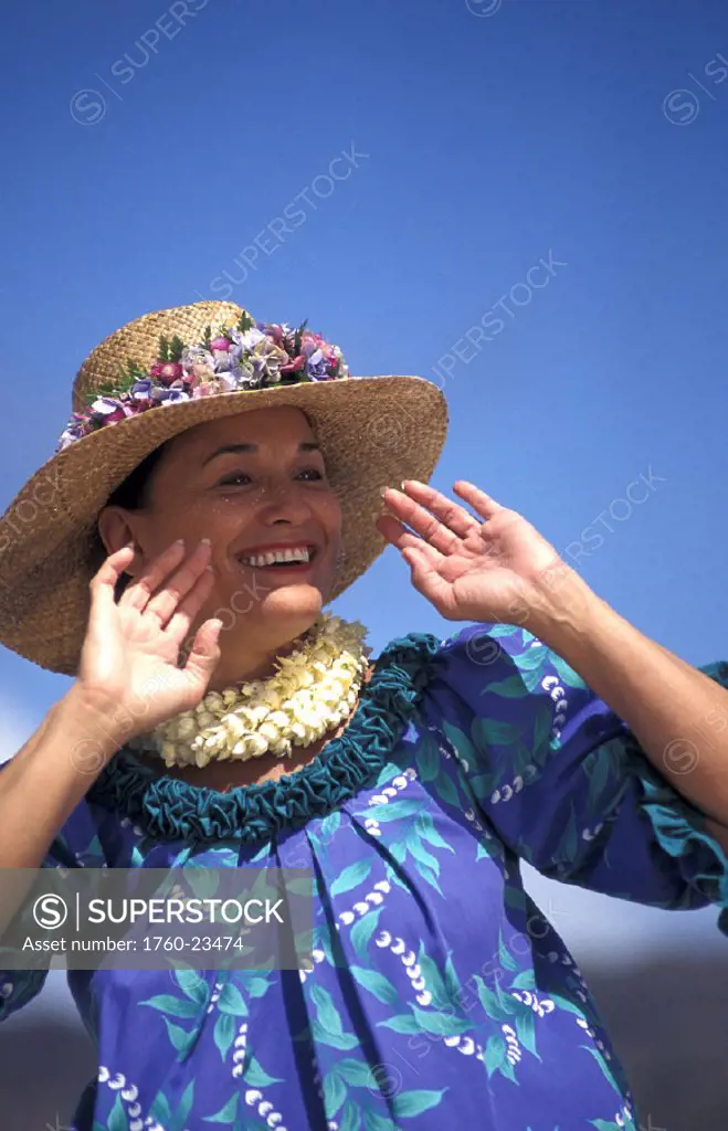 Close-up of older Hawaiian woman (tutu) dancing on beach