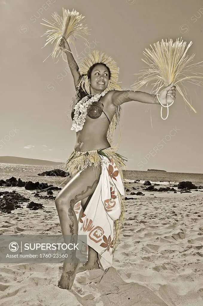 Beautiful Hawaiian woman dancing hula on ocean shoreline, hand colored