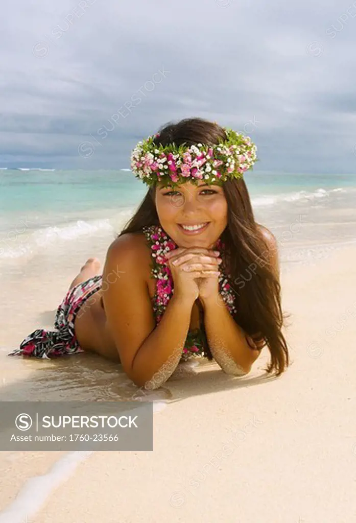 Hawaii, Oahu, Lanikai, Beautiful Hawaiian girl in haku and lei, laying on the beach