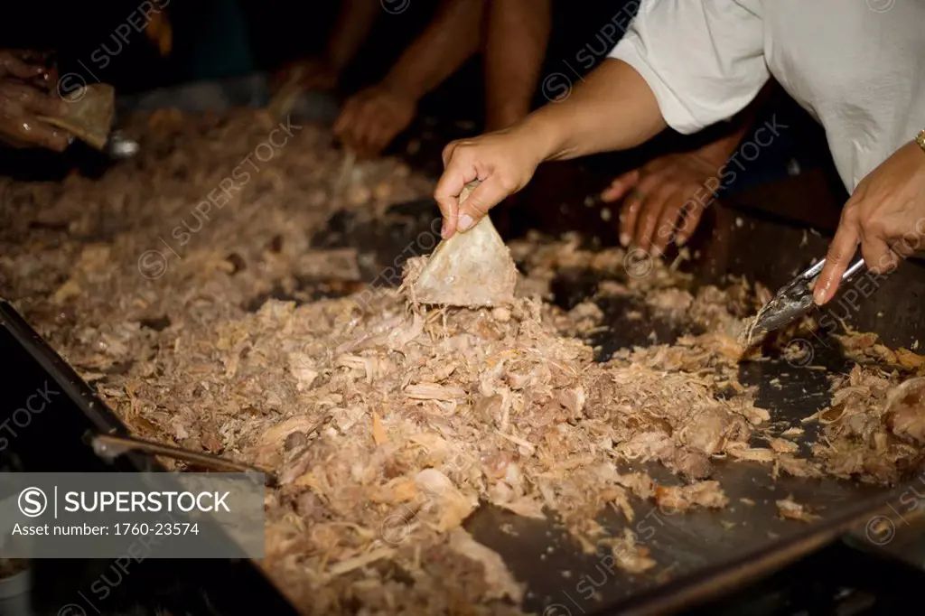 Hawaii, Oahu, Hawaiian culture, Kalua pig underground roast pig being prepared to serve.