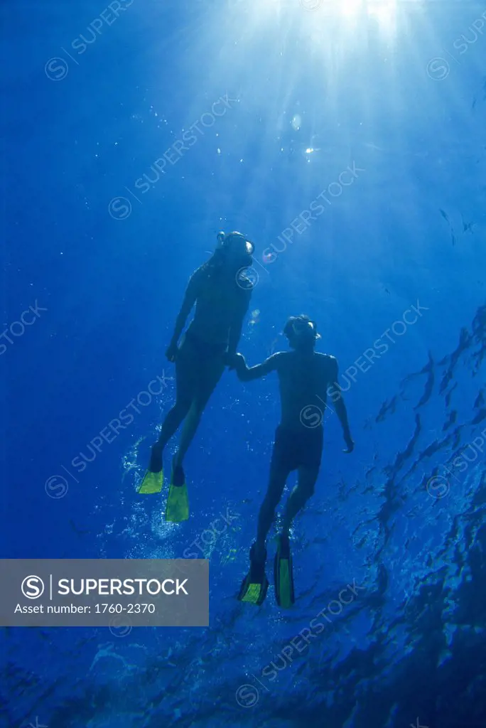 Hawaii view fr beneath couple snorkel @ surface, sunburst sunrays D1363 Pacific Ocean