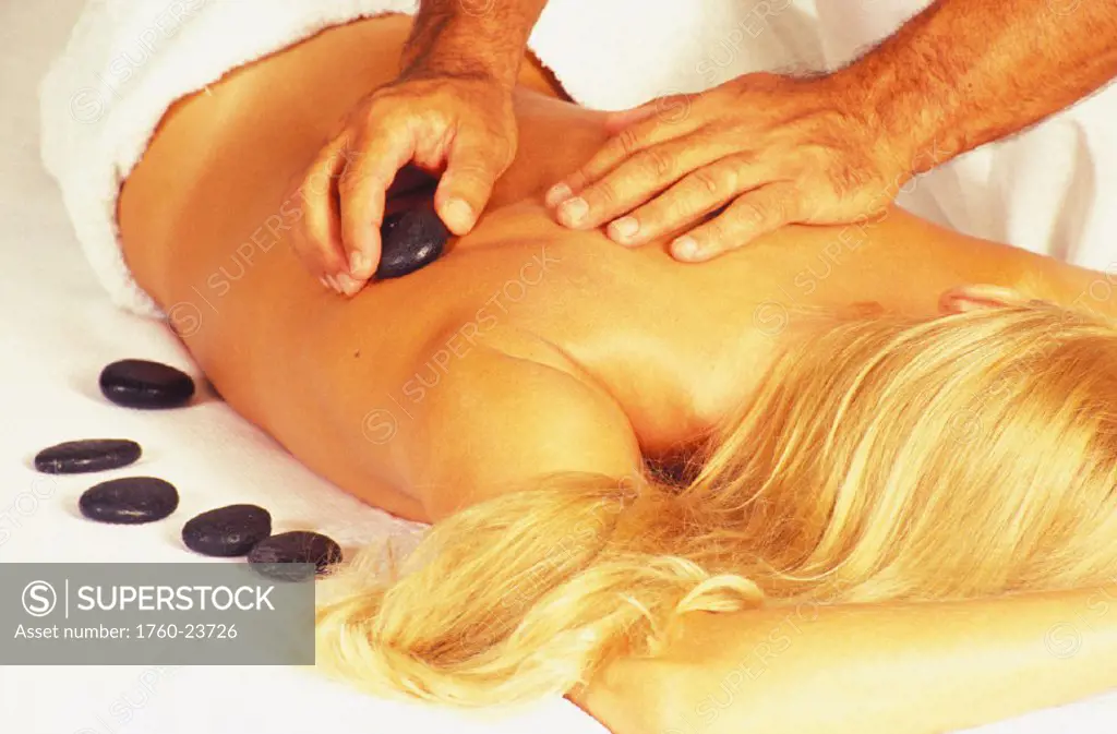 Girl receiving stone massage treatment