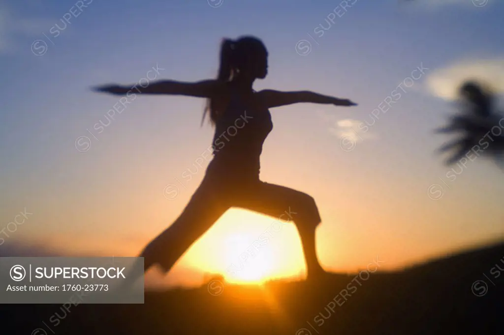 Hawaii, Maui, Olowalu, woman doing yoga at sunset.
