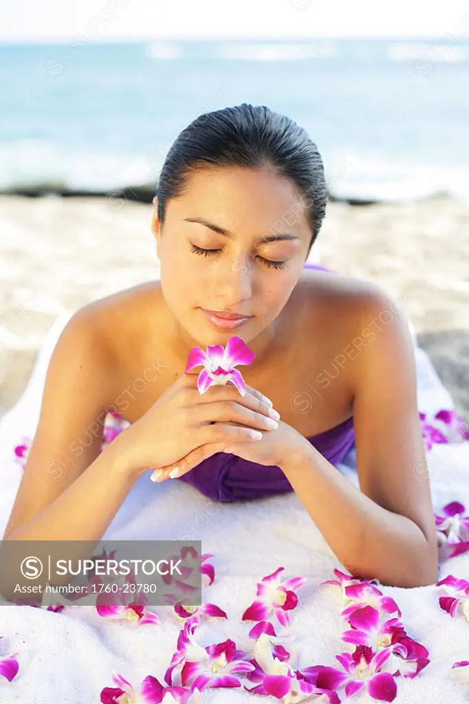Girl on beach with orchids