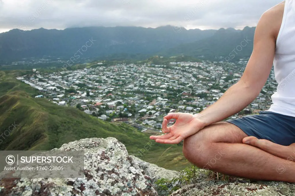 Hawaii, Oahu, Lanikai, Male hiker admiring view of doing yoga at the top of the Pill Box hike.