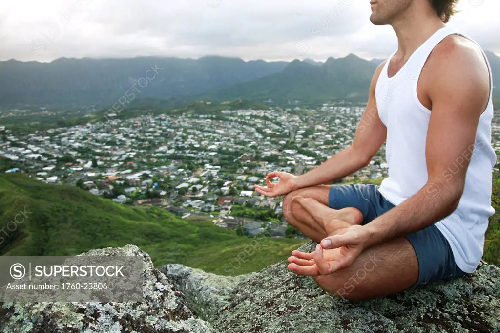 Hawaii, Oahu, Lanikai, Male hiker admiring view of doing yoga at the top of the Pill Box hike.