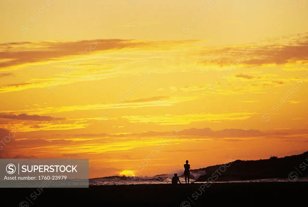 Hawaii, Kauai, Hanapepe, Salt Pond Beach Park, Two people silhouetted on beach at sunset