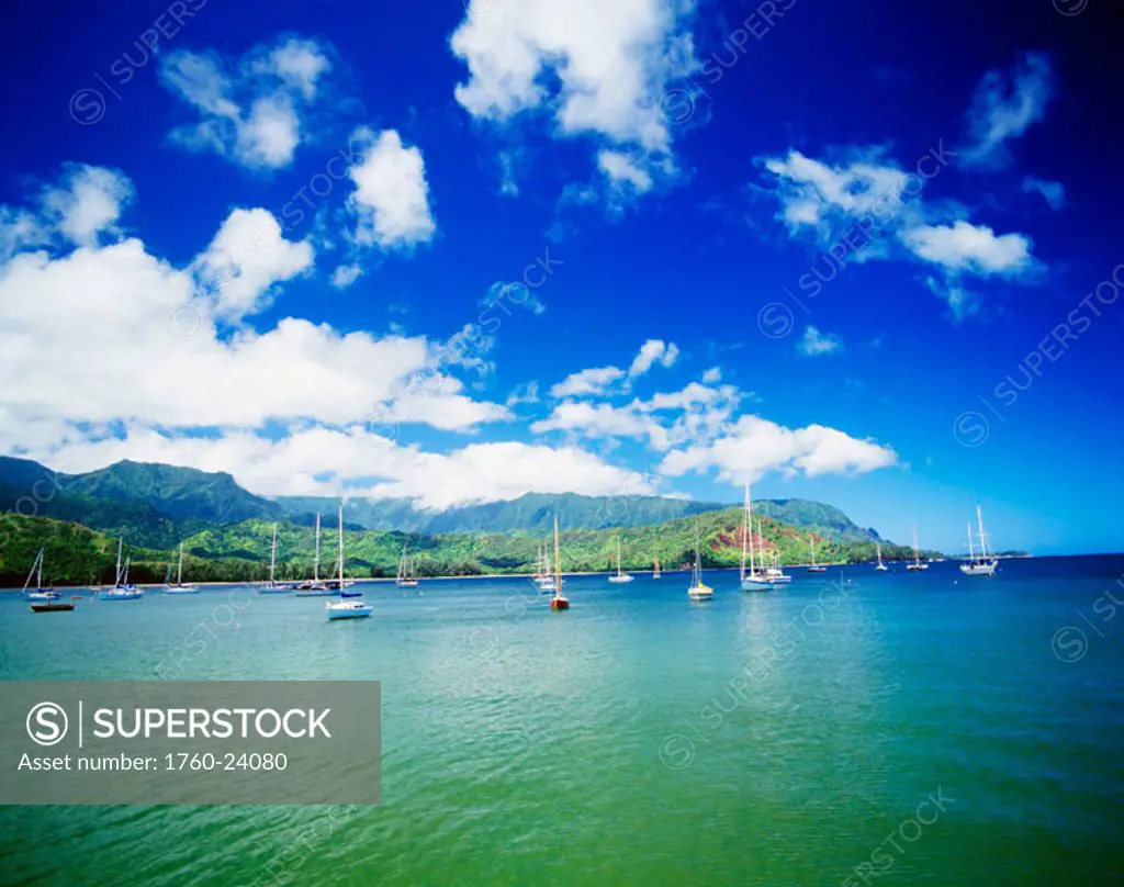 Hawaii, Kauai, Hanalei Bay with pier walkway, sailboats anchored in background