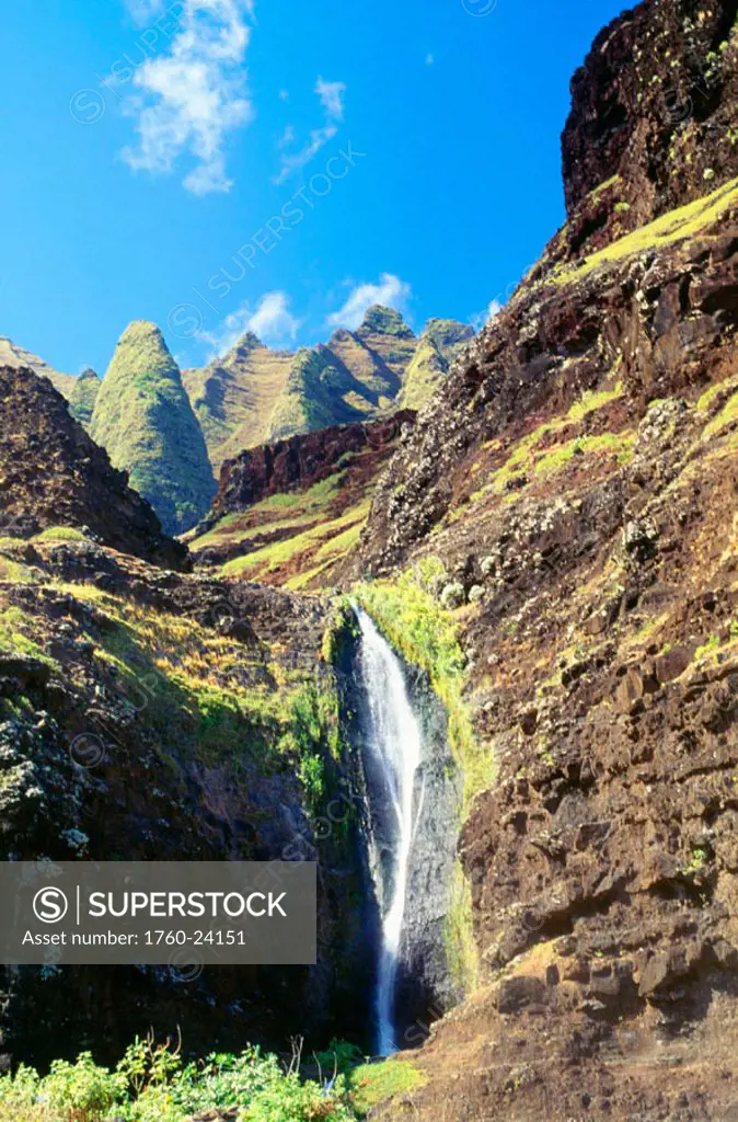 Hawaii, Kauai, NaPali Coast, waterfall coming down from the base of the Kalalau mountains