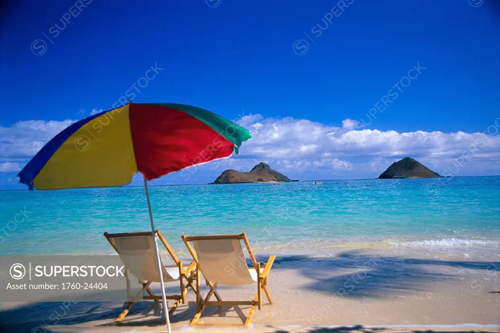 Hawaii, Oahu, Lanikai beach, two beach chairs under umbrella, turquoise water