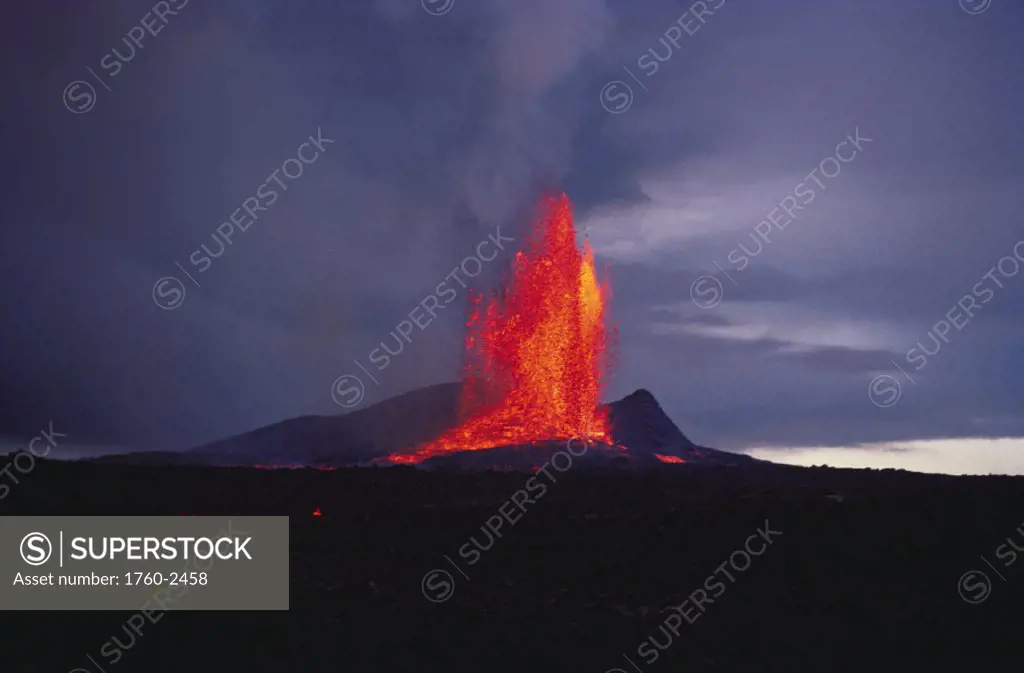 Hawaii, Big Island, Kilauea Volcano, volcanic eruption spurts hot lava into the air.