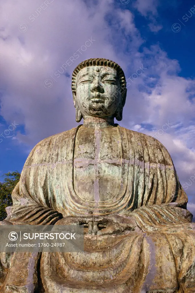 Hawaii, Maui, Lahaina Buddha statue profile with cloudy blue sky in background