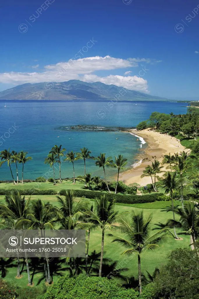 Hawaii, Maui, Wailea coastline, Ulua Beach, golf course in foreground, island in distance.