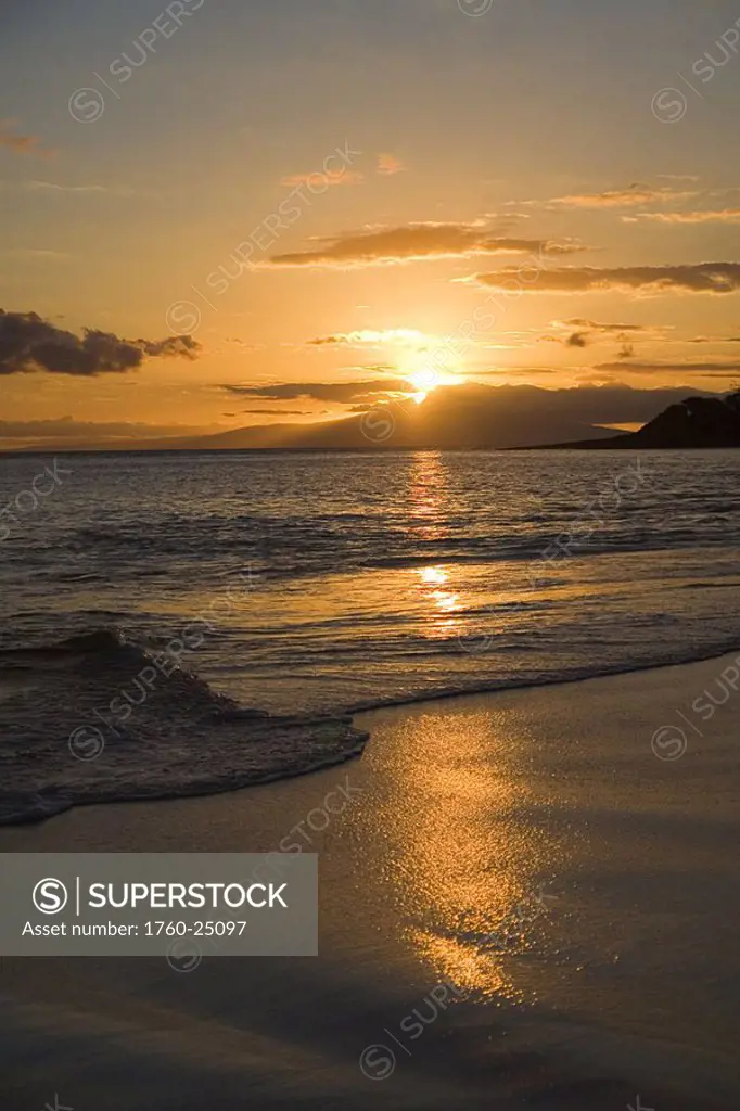 Hawaii, Maui, Makena State Park, Oneloa or Big Beach, water lapping onto shore at sunset