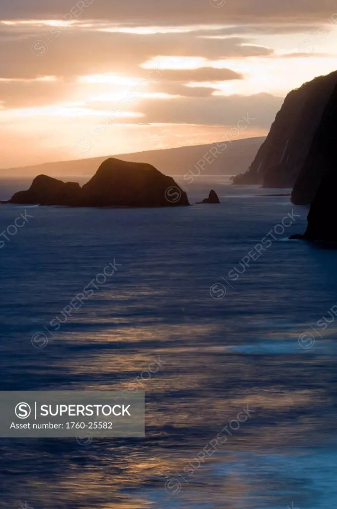 Hawaii, Big Island, North Kohala, Pololu coast and warm glowing surf sunrise.