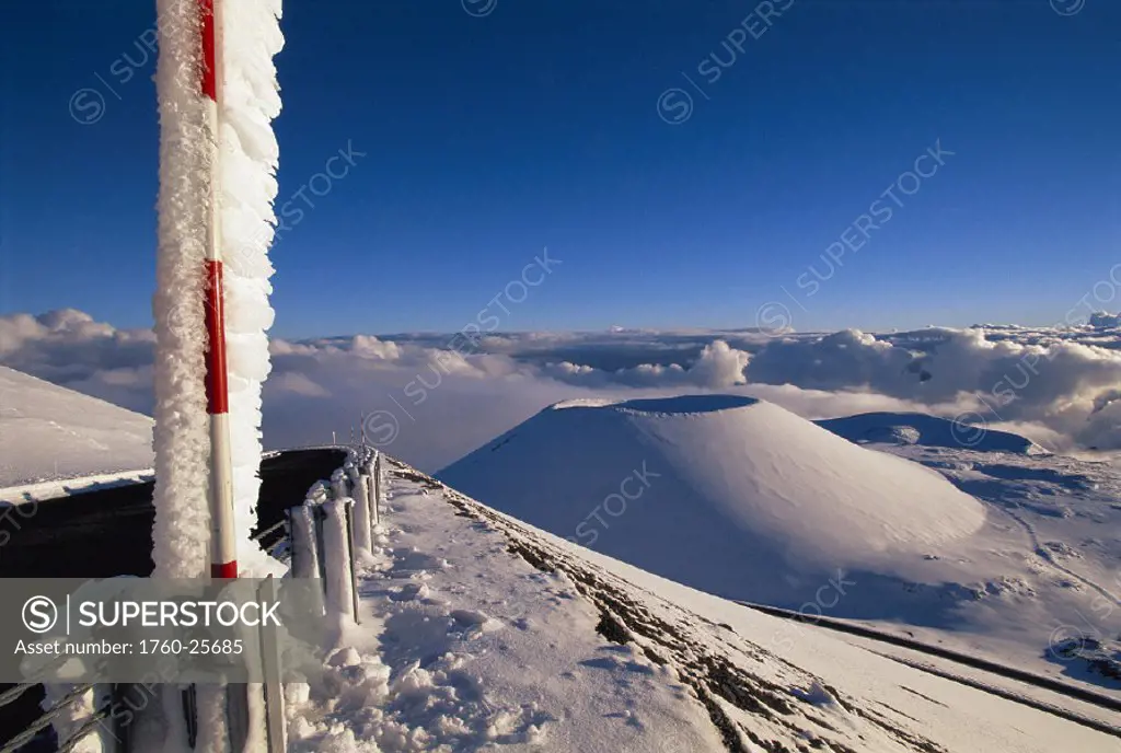 Hawaii BigIsle Mauna Kea view fr snowcapped summit w/ snow depth gauge, clear blue sky