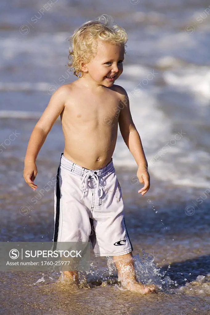 Hawaii, Maui, Baldwin Beach, Adorable little boy playing at the waters edge