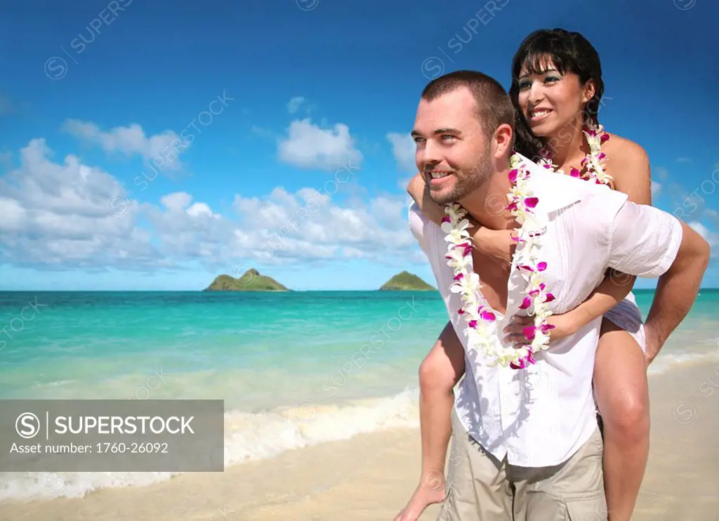 Oahu, Hawaii, Lanikai, Young couple both holding eachother.