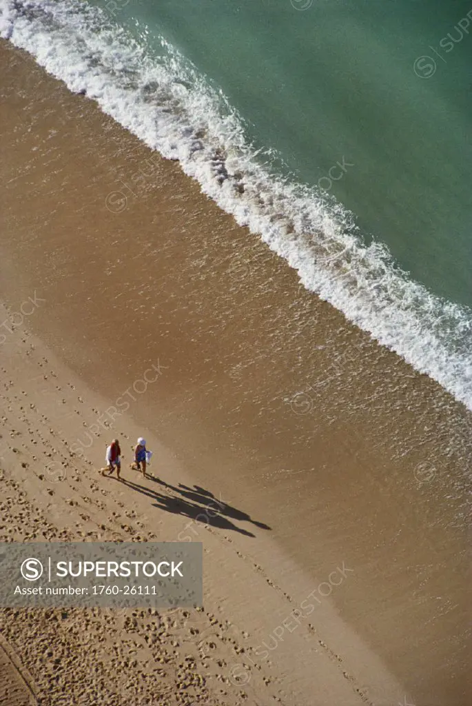 Hawaii, Couple walking on beach in the afternoon,  view from above.