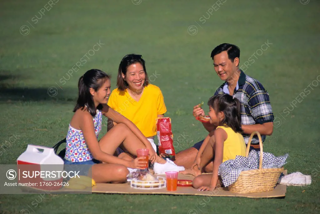 Local Asian family have picnic at park, picnic basket, cooler