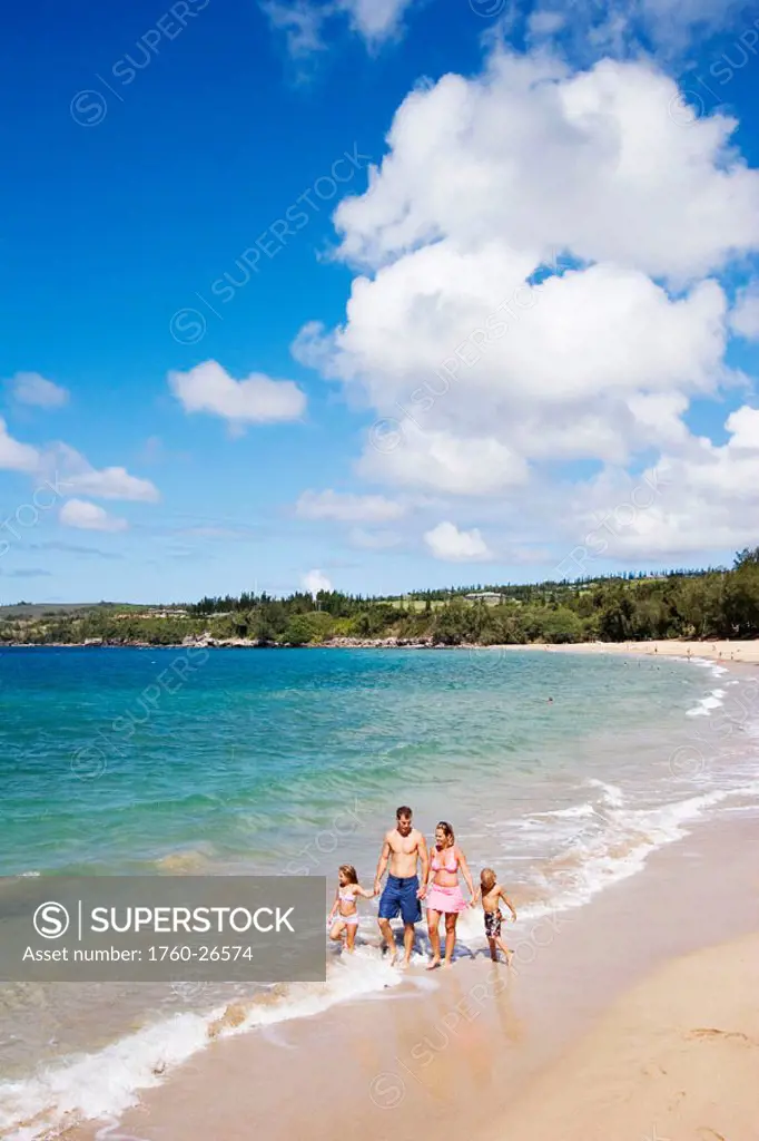 Hawaii, Maui, Kapalua, Fleming Beach, Family on vacation walking down the beach.