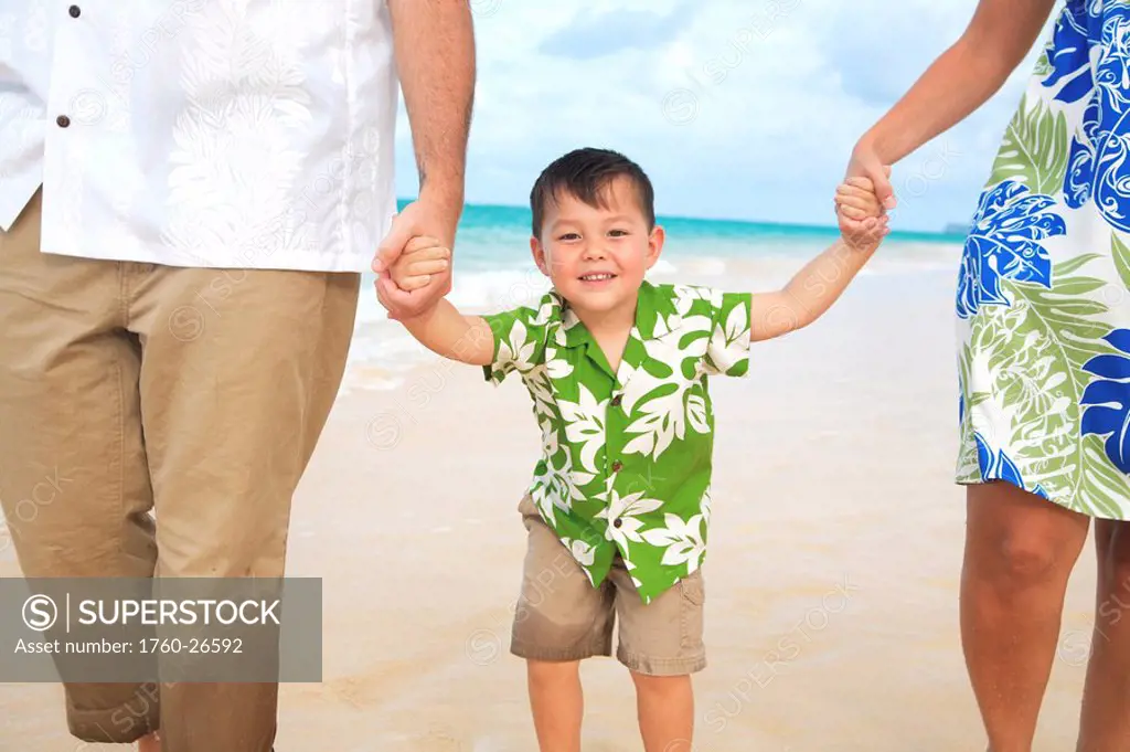 Hawaii, Oahu, Lanikai, Young Family strolling along the beach.
