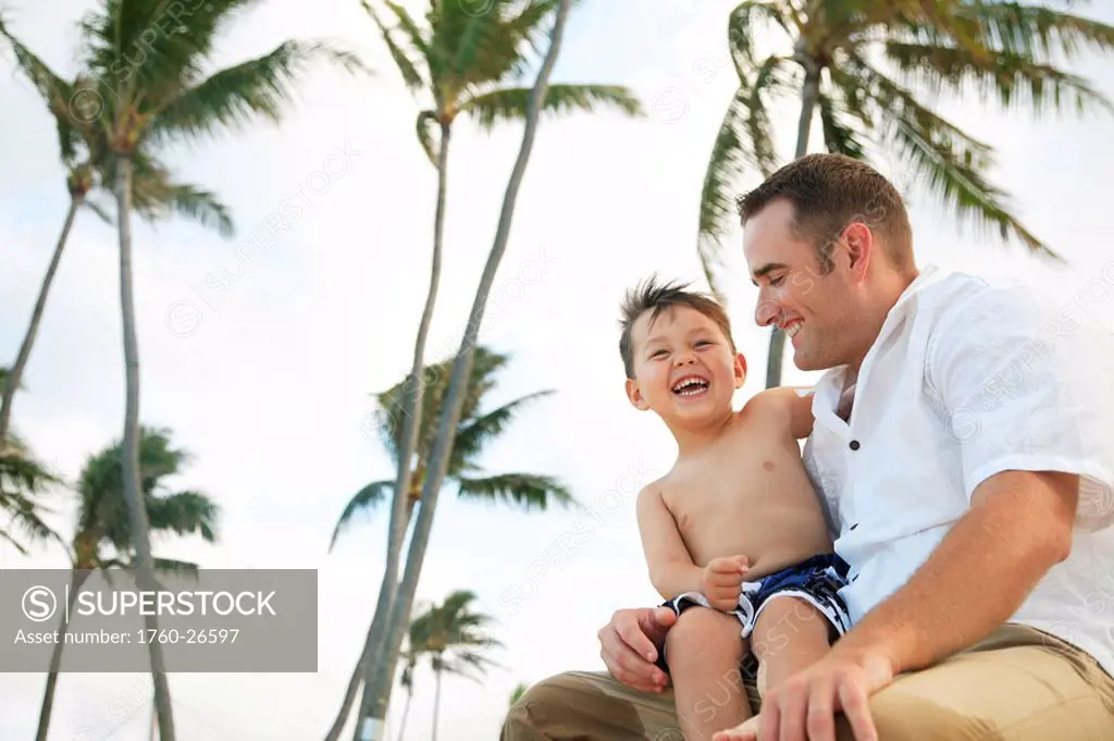 Hawaii, Oahu, A happy father interacting with his son.