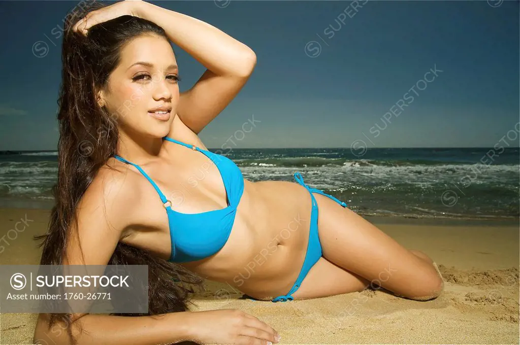Hawaii, Kauai, Kealia beach, Attractive young woman on the beach.