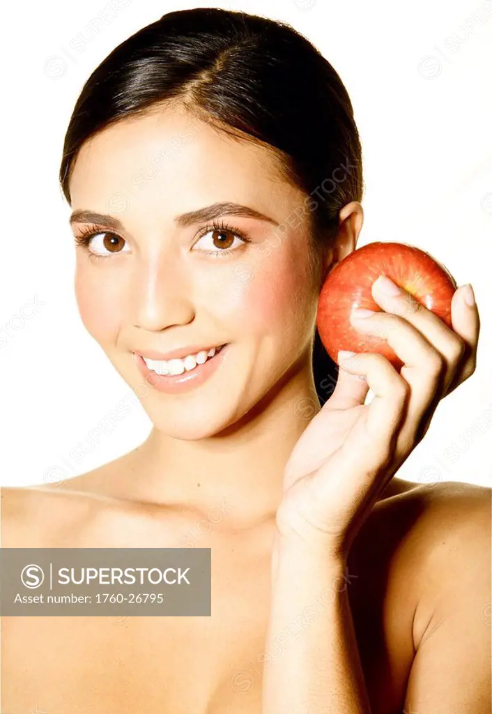 Hawaii, Studio headshot of a beautiful girl holding an apple.